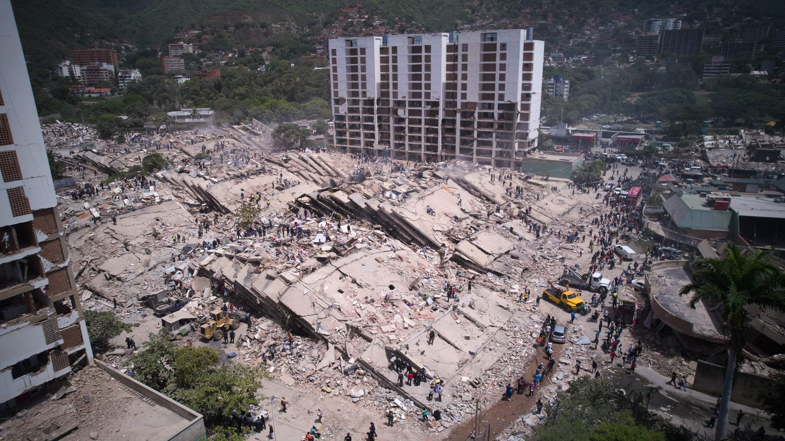 Residents and rescue workers search through the rubble two days after an earthquake struck La Guaira, Venezuela, Friday, June 26, 2026 - AP Photo: Juan Pablo Arraez